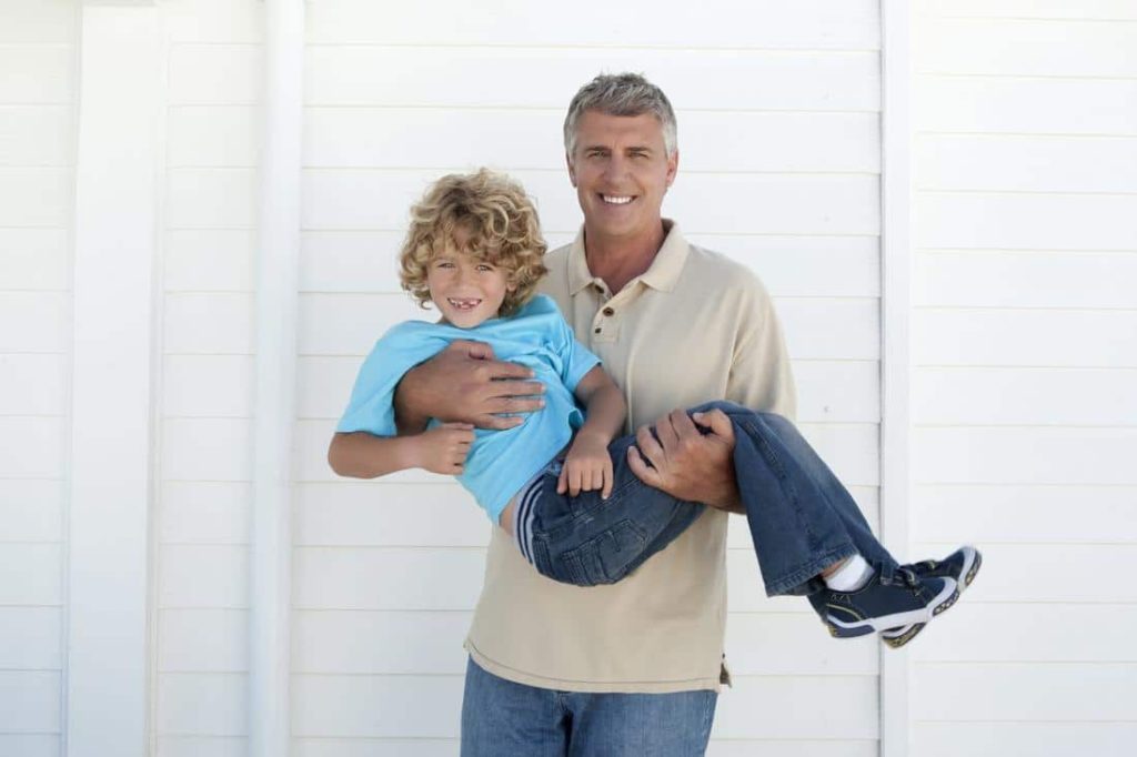 older man cradling young boy affects of age from stress